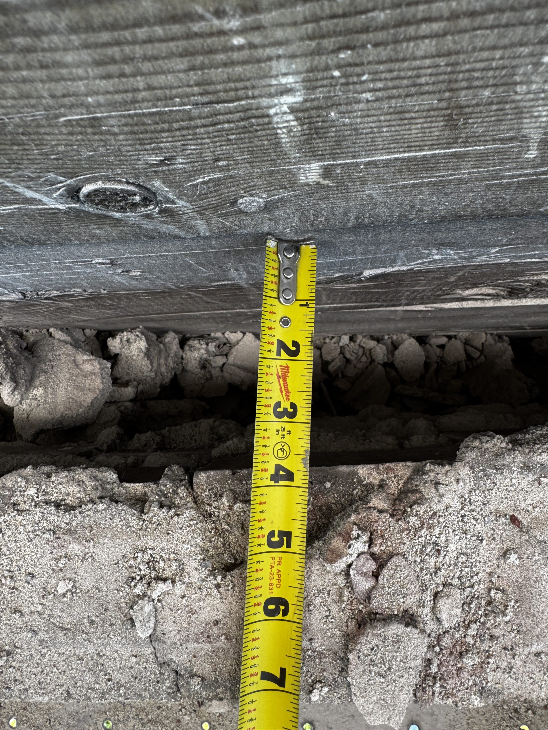 Measuring tape showing the extent of brick movement and shifting of 10 E Main building